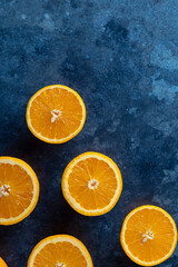 Fresh orange slices on a dark blue background