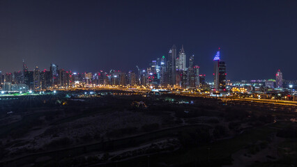 Dubai Marina skyscrapers and golf course all night timelapse, Dubai, United Arab Emirates