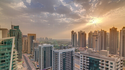 Obraz premium Sunrise view of various skyscrapers and towers in Dubai Marina from above aerial timelapse