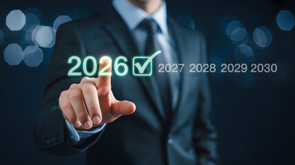 Businessman selecting 2026 on a digital interface for future planning