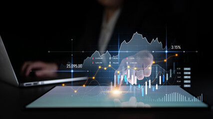 Business professional engages with dynamic financial data on a touchscreen display, illustrating modern analytics techniques in a dark work environment. Scalp