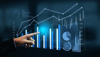 A business professional engages with a digital screen, analyzing graphs and charts that represent data trends in a modern office setting, showcasing technology and strategy. Scalp
