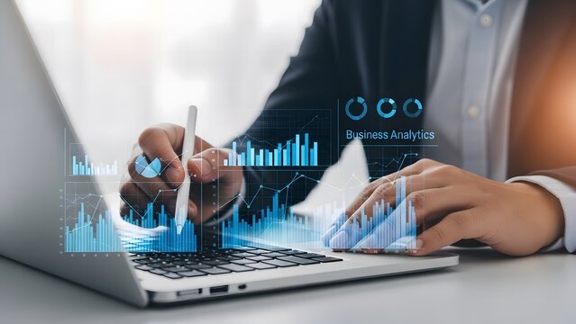 Businessman analyzing financial data with holographic charts on a laptop for business growth and investment strategy