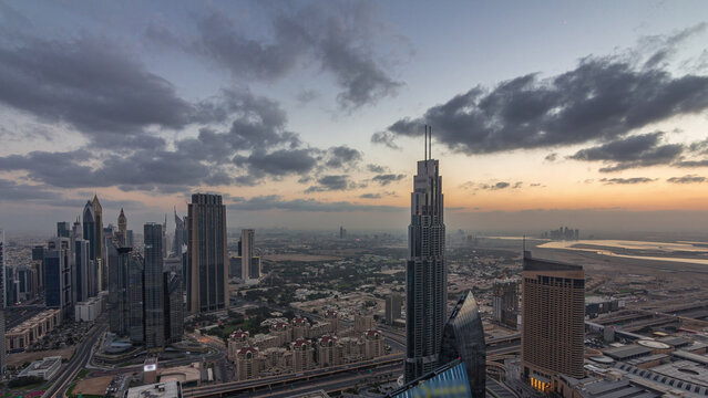 Dubai International Financial Centre district with modern skyscrapers night to day timelapse