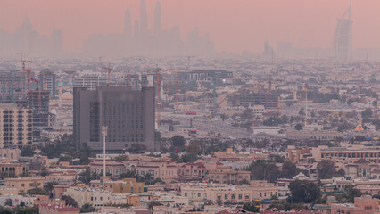 Sunset rooftop view on Dubai Marina with JLT skyline and Jumeirah beach in orange light, Dubai,United Arab Emirates
