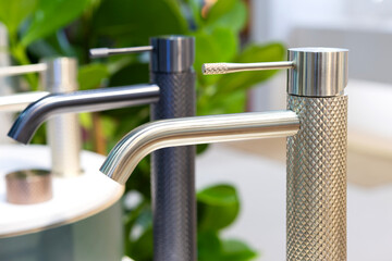 Stainless steel sink faucets on display for sale in the booth