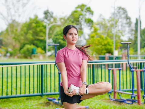 Fitness woman enjoying light exercise at park in holiday. Female workout stretching routine in vacation. Healthy lifestyle people wellness. People exercise new year motivation focus transformation  - Powered by Adobe