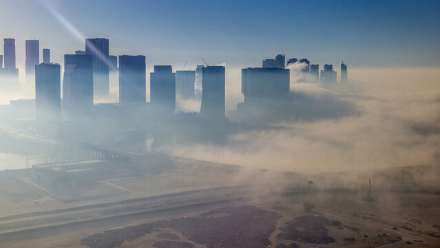 Skylines under the thick fog at the street timelapse of Abu Dhabi at morning