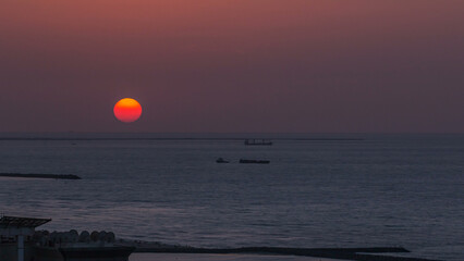 Sunset in Ajman aerial view from rooftop timelapse. United Arab Emirates.