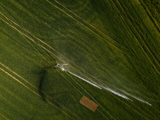 Farmland from above - aerial image of a lush green field being irrigated