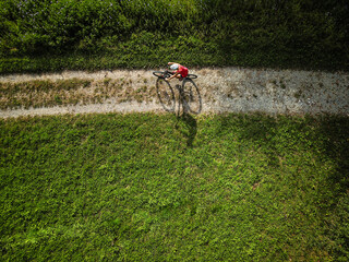 Pretty, young woman riding her mountain bike on a forest path. Enjoying active leisure time outdoors.