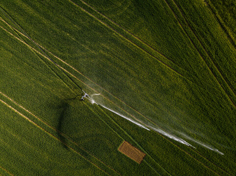 Farmland from above - aerial image of a lush green field being irrigated