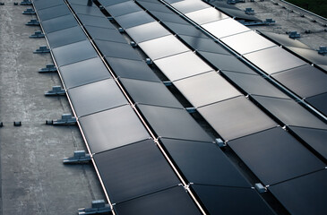 Photovoltaic Solar Panel Installation on Industrial Flat Roof for Sustainable Energy Production