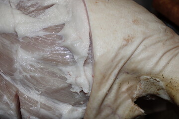 Large piece of fresh meat displayed on a butcher's table during early morning hours