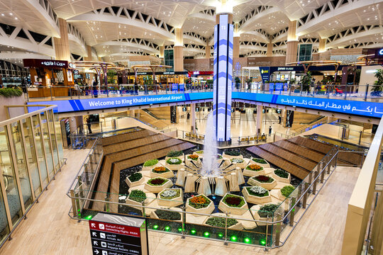 Riyadh, Saudi Arabia - November 25, 2025: Modern and Spacious Interior of King Khalid International Airport (RUH) Terminal with Central Fountain and Shopping Area in Riyadh, Saudi Arabia