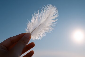 Hand Releasing a White Feather into the Sunlight for Forgiveness