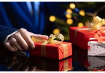 Business Professional Giving Christmas Gift on Reflective Table