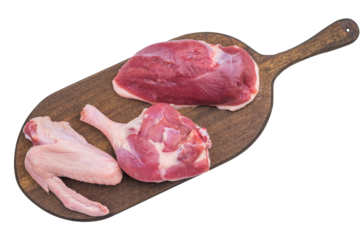 Fresh uncooked duck cuts on rustic wooden board against bright surface perfect for culinary preparation visuals and recipe content.