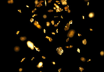 キラキラと舞い落ちるメタリックなコンフェッティの背景素材　金色の紙吹雪