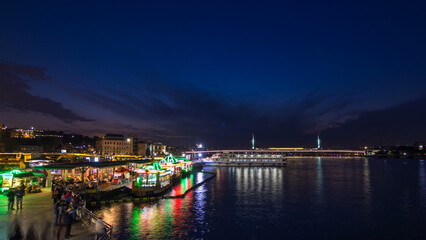 Passenger Ferries in the Golden Horn after sunset day to night timelapse, Istanbul skyline, Turkey