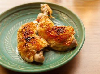 Roasted chicken on a green vintage plate