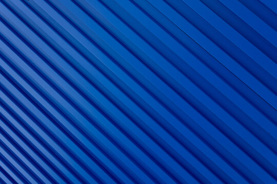 Blue building zinc wall backdrop,Corrugated metal sheet wall. Background of blue corrugated steel sheets with diagonal corrugations as wall of modern building with copy space. Selective focus
