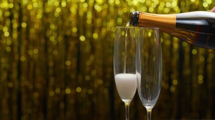 pouring champagne wine from bottle in a flute glasses. champagne poured in a champagne glasses. - Powered by Adobe