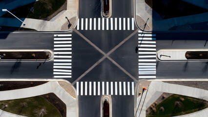 Fototapeta premium A clean overhead view of an empty crosswalk intersection showing balanced geometric street shapes