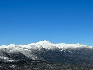 Snow-Covered Mountain Range Under Clear Blue Sky