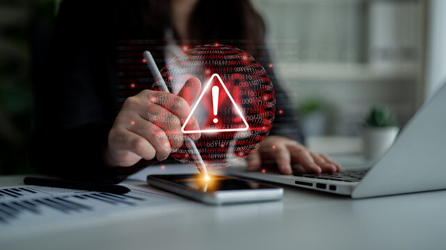 A professional woman interacts with a smartphone displaying a warning symbol, illustrating the critical theme of technology risks and data security in the workplace. Gantry