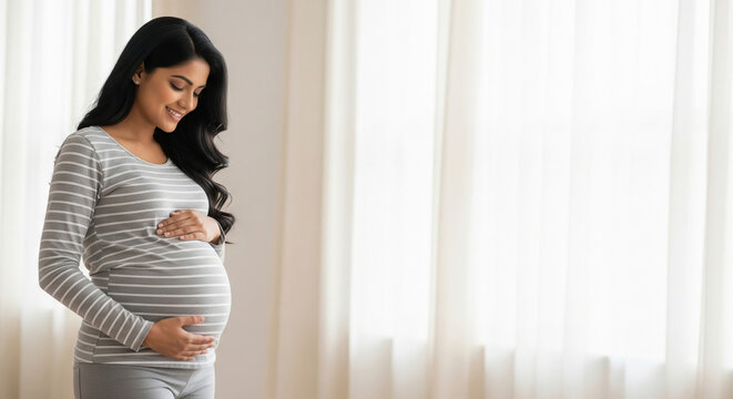 Happy Pregnant Indian Woman Cradling Her Baby Bump Joyfully