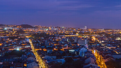 Rooftops of Porto's old town on a warm spring evening timelapse day to night, Porto, Portugal