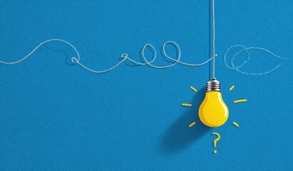 A bright yellow lightbulb with glowing rays hangs on a blue surface, concept of an idea