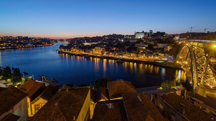 Obraz premium Panorama of old city Porto at river Duoro after sunset day to night timelapse, Oporto, Portugal