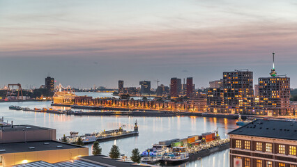 Fototapeta premium Panoramic aerial day to night timelapse of Katendrecht peninsula and Maashaven harbour in Rotterdam, The Netherlands.