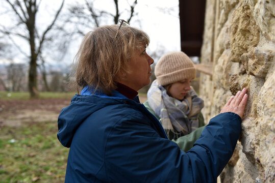 Arhitect women studying on stone building wall