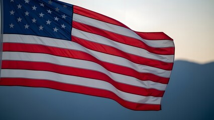Obraz premium Waving american flag against a soft sky at dusk symbol of patriotism