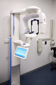 Modern panoramic dental X ray machine diagnostics in dentistry. CBCT Cone Beam Computed Tomography medical technique uses cone shaped X ray beam to create 3D images of teeth, jaw, nerves and sinuses.