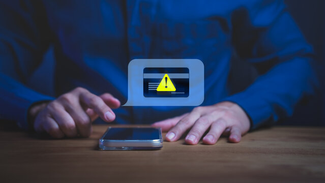 Person holding smartphone with warning message, symbolizing online payment error, digital banking security risk, scammer, and financial fraud prevention. Credit card alert notification concept.