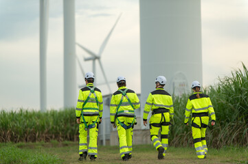 Fototapeta premium Engineers working on site in wind turbine farm, Wind turbines generate clean energy source, Eco technology for electric.