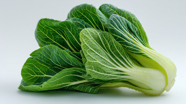 Close up of fresh bok choy with green leaves on a white background