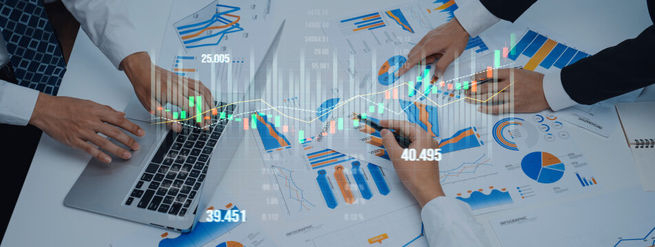 A group of professionals collaborates on analyzing financial data and charts on a desk. The image illustrates teamwork and strategy in a modern office setting, showcasing growth potential. Scalp
