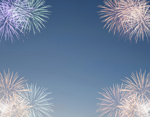 Vibrant bursts of colorful fireworks creating a festive frame against a clear evening sky, a perfect background for celebrations and special events