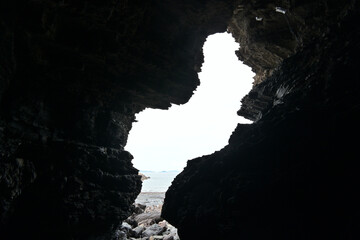 A view of the exit from the inside of a naturally formed cave somewhere on the rocky cliff