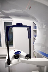 Modern panoramic dental X ray machine diagnostics in dentistry. CBCT Cone Beam Computed Tomography medical technique uses cone shaped X ray beam to create 3D images of teeth, jaw, nerves and sinuses.