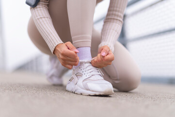 Woman tying shoelaces preparing for her workout run