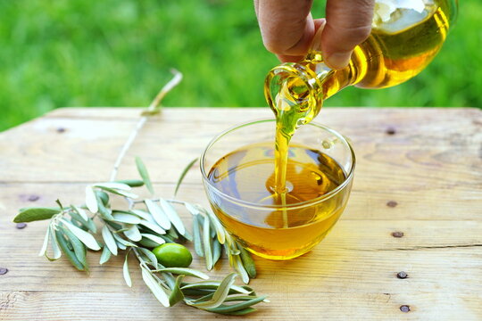 Pouring olive oil into a glass bowl