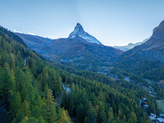 Matterhorn Mountain and Green Larches in Autumn in Evening. Aerial View. Swiss Alps. Zermatt, Valais, Switzerland. Wide Shot