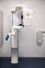 Modern panoramic dental X ray machine diagnostics in dentistry. CBCT Cone Beam Computed Tomography medical technique uses cone shaped X ray beam to create 3D images of teeth, jaw, nerves and sinuses.