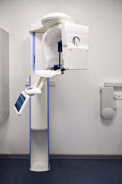 Modern panoramic dental X ray machine diagnostics in dentistry. CBCT Cone Beam Computed Tomography medical technique uses cone shaped X ray beam to create 3D images of teeth, jaw, nerves and sinuses.